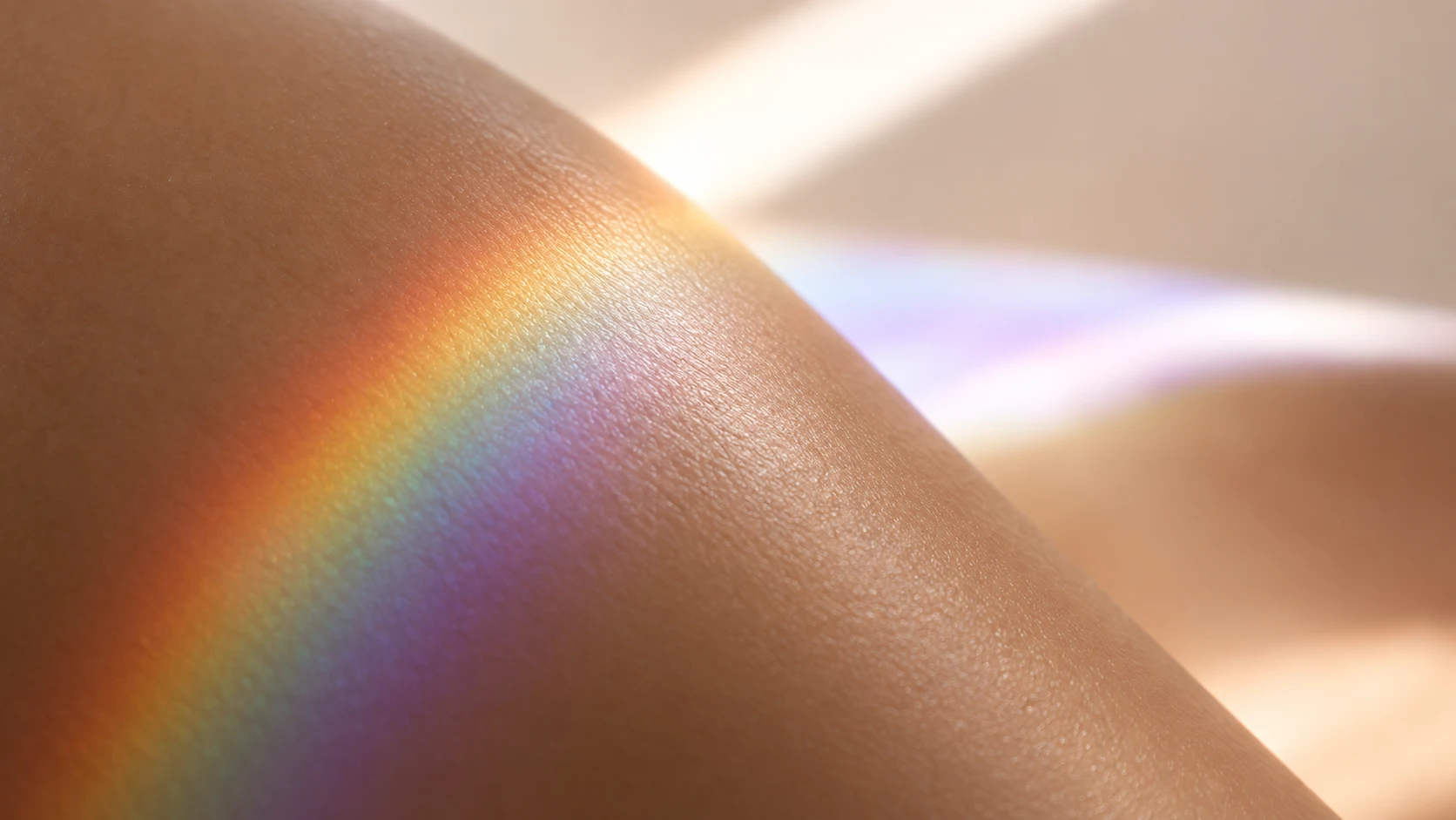A gentle rainbow spectrum of sunlight cast across radiant, healthy bare skin